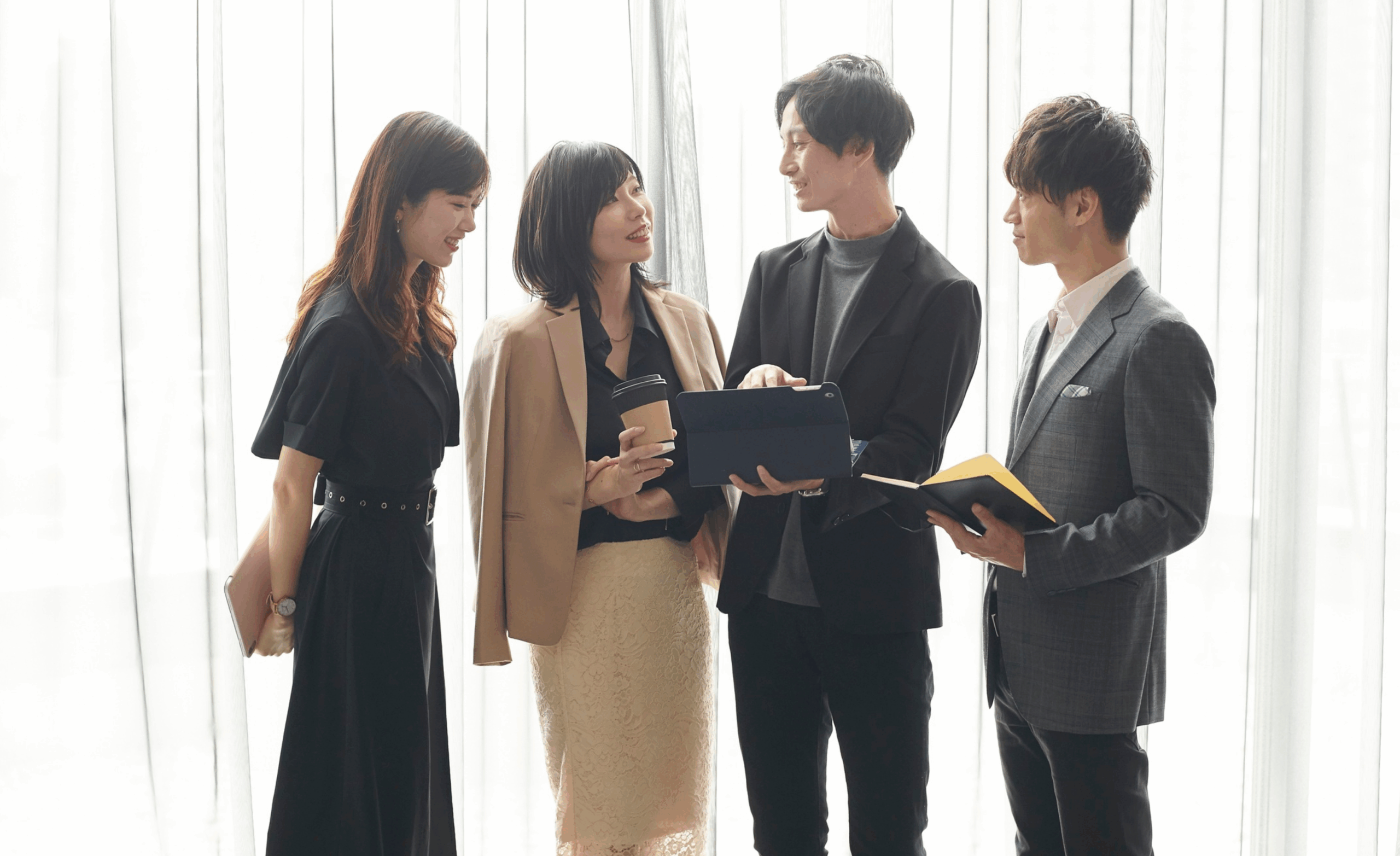 Decorative image depicting four coworkers talking.