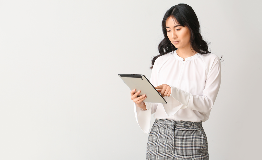 Decorative image depicting woman working on tablet.