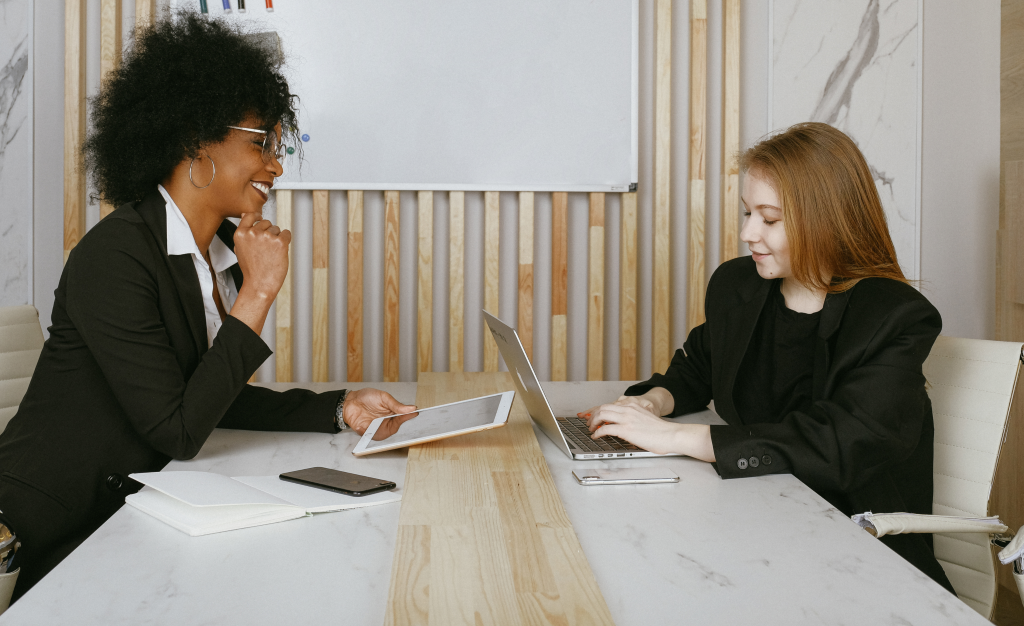 Decorative image depicting two women working together.