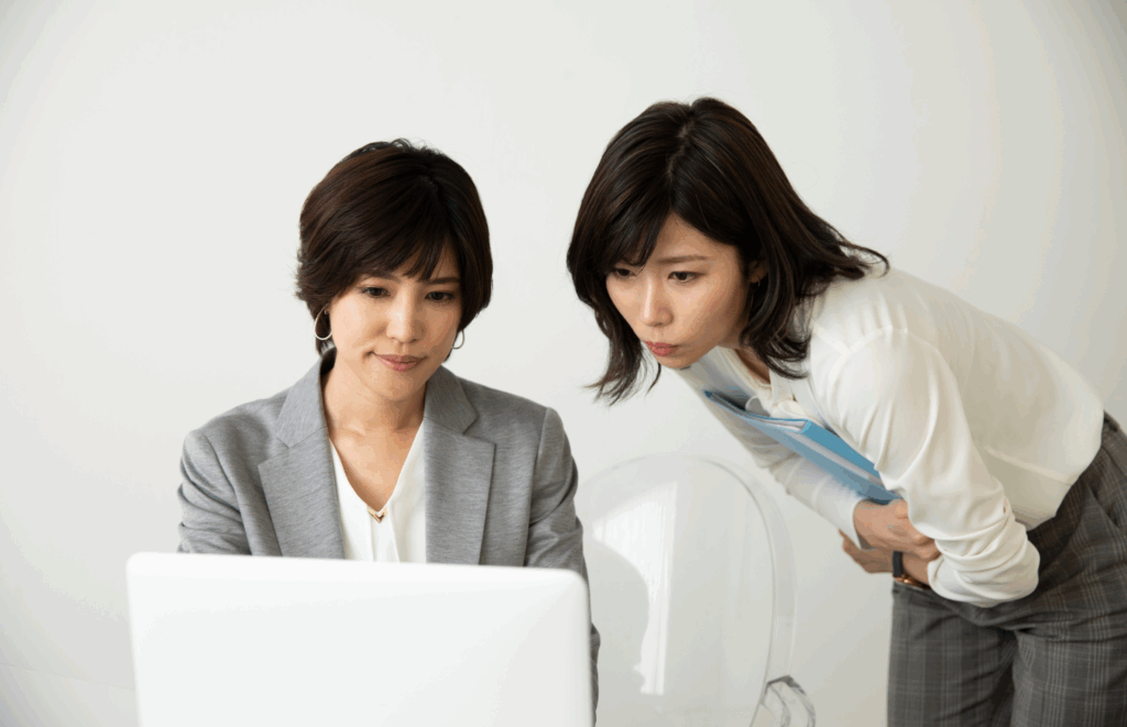 Decorative image of art gallery professionals looking at a computer screen