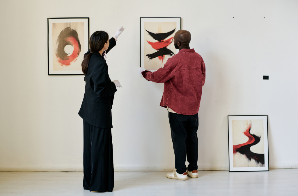 Decorative image of a man and woman hanging a piece of art