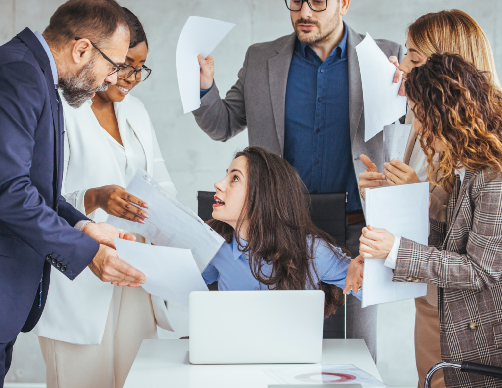 Decorative image of woman being overwhelmed by workload from coworkers
